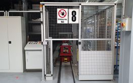 Image shows an inward transfer system for stores with a safety fence