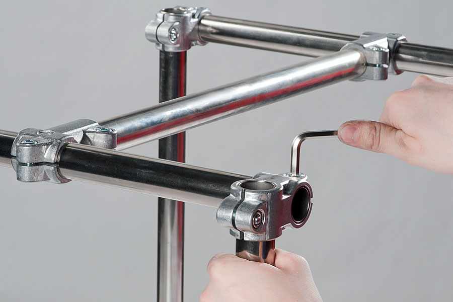 Una persona muestra la aplicación de uniones de aluminio para tubos